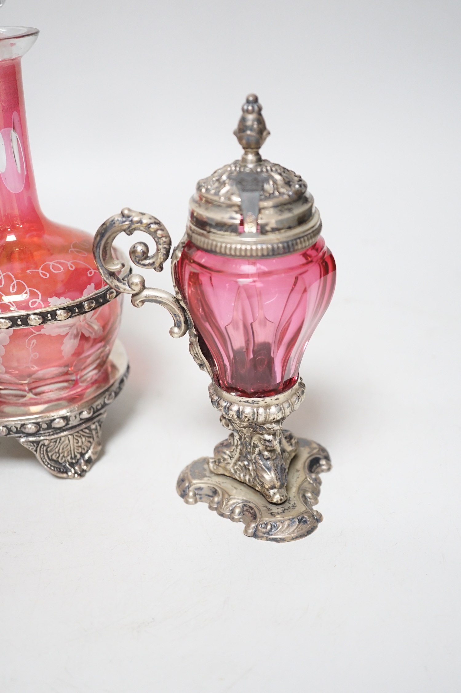A plated cranberry two bottle and two cruet stand and a similar plated and cranberry mustard, stand 29cm high